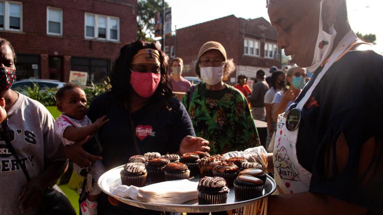 Brown Sugar Bakery employees hand out free cupcakes as part of the 75th Street Boardwalk grand opening on Saturday, Sept. 5, 2020. (Grace Del Vecchio / WTTW News)