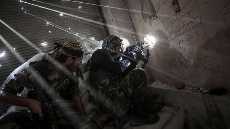 Rebel fighters watch over the enemy position during skirmishes last year in Aleppo, Syria. (Courtesy Creative Commons/Narciso Contreras)