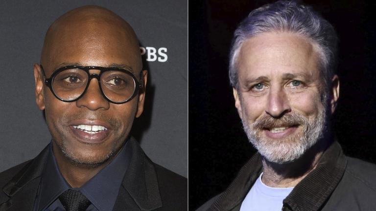 Comedian Dave Chappelle arrives at Kennedy Center for the Performing Arts to receive the 22nd Annual Mark Twain Prize for American Humor in Washington on Oct. 27, 2019, left, and comedian Jon Stewart performs at the 9th Annual Stand Up For Heroes event in New York on Nov. 10, 2015. (AP Photo)
