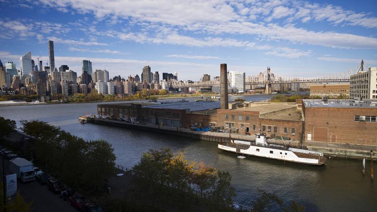 In this Wednesday, Nov. 7, 2018, photo, a rusting ferryboat is docked next to an aging industrial warehouse on Long Island City's Anable Basin in the Queens borough of New York. (Mark Lennihan /AP Photo)
