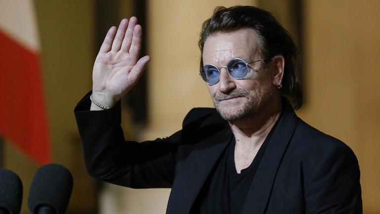 In this Monday, Sept. 10, 2018, file photo, U2 singer Bono waves goodbye to the media after a meeting with French President Emmanuel Macron at the Elysee Palace in Paris, France. (Michel Euler / AP File Photo)