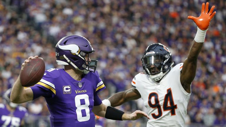 Minnesota Vikings quarterback Kirk Cousins (8) looks to throw a pass over Chicago Bears outside linebacker Leonard Floyd (94) during the first half of an NFL football game, Sunday, Dec. 30, 2018. (Bruce Kluckhohn / AP Photo)