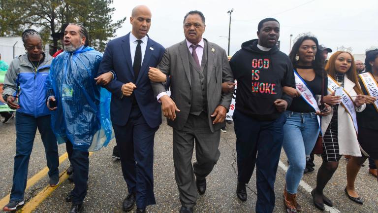 U.S. Sen. Cory Booker, D-N.J., third from left, and the Rev. Jesse Jackson march to cross the Edmund Pettus Bridge Sunday, March 3, 2019, during the Bloody Sunday commemoration in Selma, Ala. The infamous “Bloody Sunday” on March 7, 1965, galvanized support for the passage of the Voting Rights Act that year. (AP Photo / Julie Bennett)