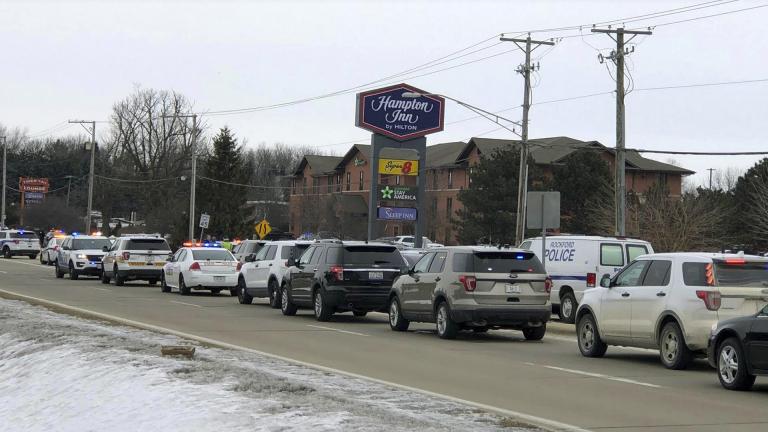 Area law enforcement vehicles gather near the scene of a shooting in Rockford, Ill., Thursday, March 7, 2019. (Ken DeCoster / Rockford Register Star via AP)