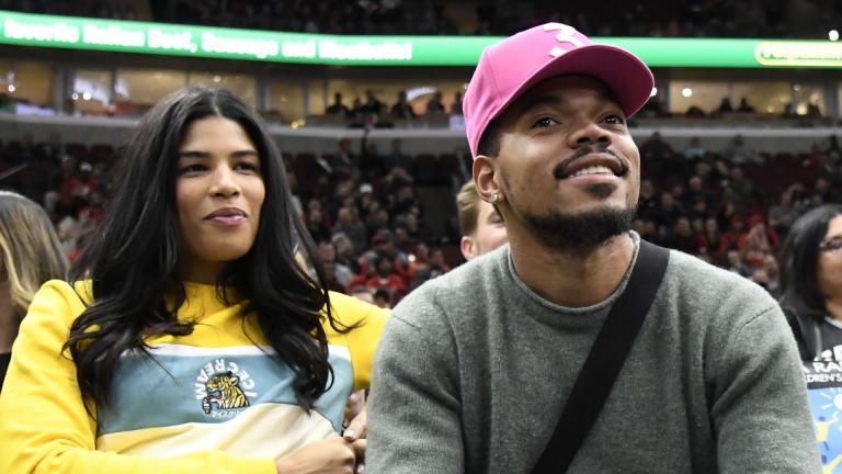 In this Nov. 26, 2018 file photo, Chance the Rapper, right, and Kirsten Corley appear during the second half of an NBA basketball game between the Chicago Bulls and the San Antonio Spurs in Chicago. (AP Photo / David Banks, File)