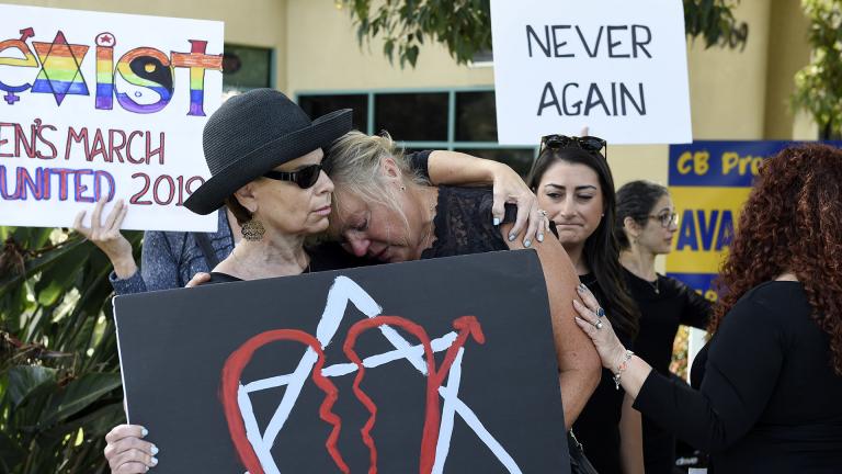 Leslie Gollub, left, and Gretchen Gordon hug at a vigil held to support the victims of the Chabad of Poway synagogue shooting, Sunday, April 28, 2019, in Poway, California. (AP Photo/Denis Poroy) Leslie Gollub, left, and Gretchen Gordon hug at a vigil held to support the victims of the Chabad of Poway synagogue shooting, Sunday, April 28, 2019, in Poway, California. (AP Photo/Denis Poroy)