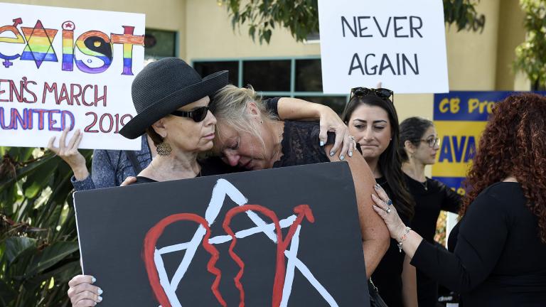 Leslie Gollub, left, and Gretchen Gordon hug at a vigil held to support the victims of the Chabad of Poway synagogue shooting, Sunday, April 28, 2019, in Poway, California. (AP Photo/Denis Poroy)