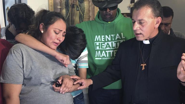 In this Tuesday, May 21, 2019 photo provided by WBEZ Radio is Adilene Marquina, left, as she sobs after announcing she will be seeking sanctuary inside Faith, Life and Hope Mission church on Chicago's Southwest Side. Hugging her is her son, Johan as Rev. Jose Landaverde, right, comforts her. (María Ines Zamudio / WBEZ Radio via AP)