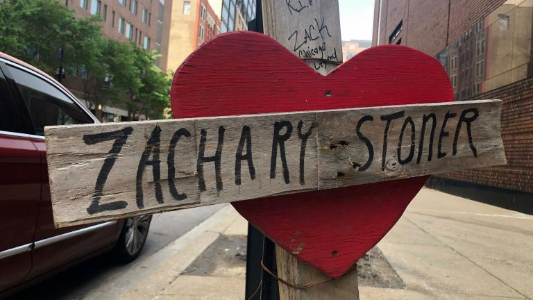 In this May 22, 2019 photo, a makeshift cross marking the spot where Zachary Stoner was killed on May 30, 2018, in a drive-by shooting in downtown Chicago. (AP Photo / Michael Tarm)