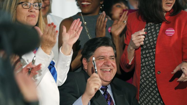 Illinois Gov. J.B. Pritzker signs the Reproductive Health Act into law with bill sponsors Illinois State Senator Melinda Bush, left, and Illinois State Rep. Kelly Cassidy, right, at the Chicago Cultural Center on Wednesday, June 12, 2019. (Jose M. Osorio / Chicago Tribune via AP) Illinois Gov. J.B. Pritzker signs the Reproductive Health Act into law with bill sponsors Illinois State Senator Melinda Bush, left, and Illinois State Rep. Kelly Cassidy, right, at the Chicago Cultural Center on Wednesday, June 12, 2019. (Jose M. Osorio / Chicago Tribune via AP)