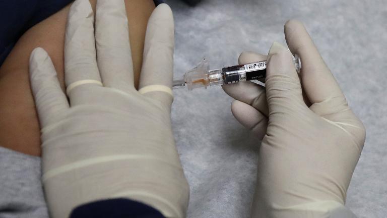 In this Jan. 12, 2018, file photo, a medical assistant at a community health center gives a patient a flu shot in Seattle. (AP Photo / Ted S. Warren, File)
