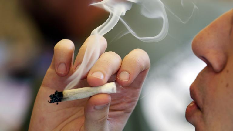 In this April 20, 2016, file photo, a man smokes a marijuana joint at a party celebrating weed in Seattle. Legalizing recreational marijuana for U.S. adults may have led to a slight decline in teen use, according to research published Monday, July 8, 2019, in JAMA Pediatrics.  (AP Photo / Elaine Thompson, File)
