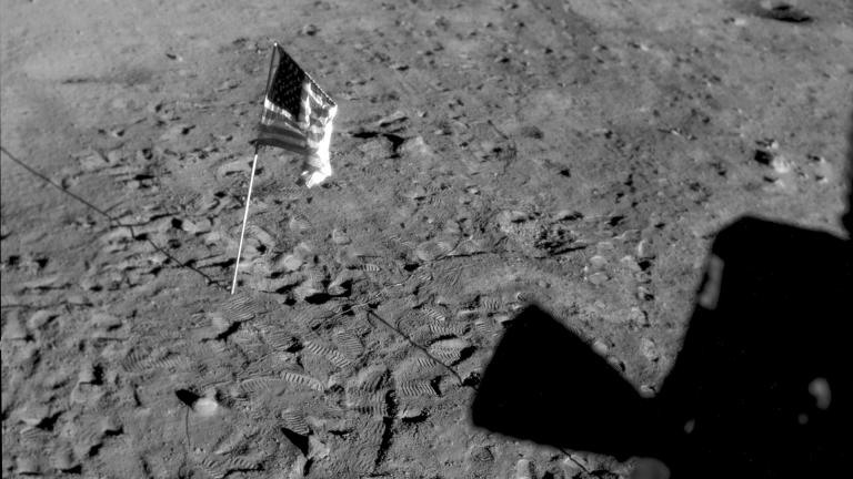 This July 21, 1969 photo made available by NASA shows the U.S. flag planted at Tranquility Base on the surface of the moon, and a silhouette of a thruster at right, seen from a window in the Lunar Module. (NASA via AP)