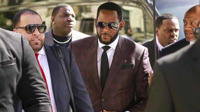 In this June 26, 2019, file photo, R&B singer R. Kelly, center, arrives at the Leighton Criminal Court building for an arraignment on sex-related felonies in Chicago. (AP Photo / Amr Alfiky, File)