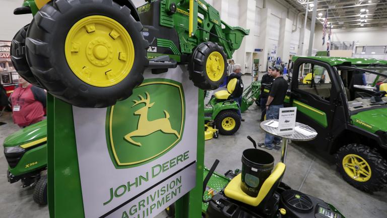 In this Feb. 23, 2018 file photo, John Deere products, including a toy tractor on the sign, are on display at a home and garden trade show in Council Bluffs, Iowa. (AP Photo / Nati Harnik, File)