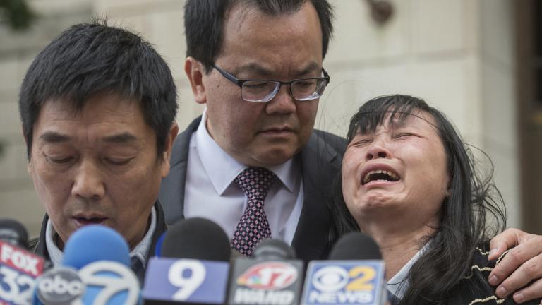 In this Monday, June 24, 2019 file photo, Lifeng Ye, the mother of slain University of Illinois scholar Yingying Zhang, cries out in grief as her husband Ronggao Zhang, left, addresses the media after a jury found Brendt Christensen guilty of Yingying Zhang’s murder, at the U.S. Federal Courthouse in Peoria, Illinois. Consoling her is family friend Dr. Kim Tee, center. (Matt Dayhoff / Journal Star via AP, File)