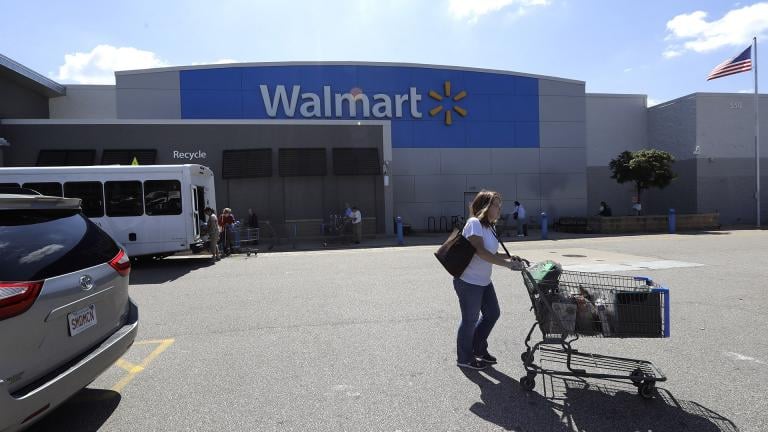 A customer pushes a shopping cart Tuesday, Sept. 3, 2019, outside a Walmart store, in Walpole, Massachusetts. (AP Photo / Steven Senne)