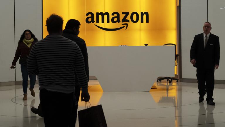 In this Feb. 14, 2019, file photo people walk into the lobby for Amazon offices in New York. (AP Photo / Mark Lennihan, File)