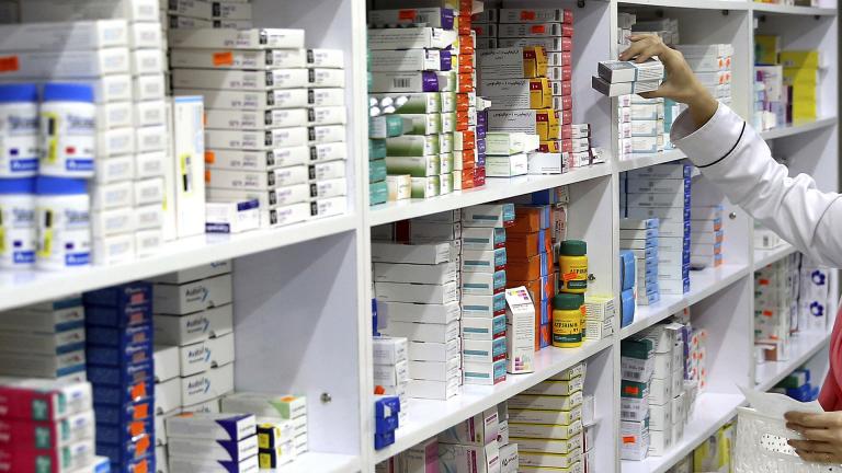 In this Nov. 5, 2018 file photo, a drugstore employee reaches for medicine from shelf in downtown Tehran, Iran. (AP Photo / Ebrahim Noroozi, File)