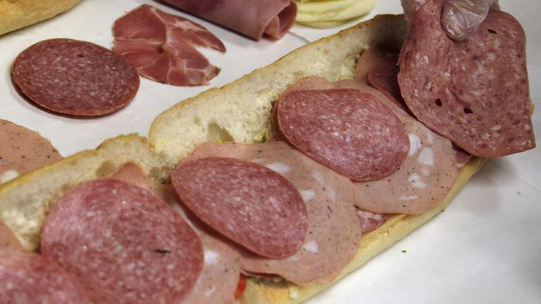  In this June 5, 2014, file photo, a man makes a submarine sandwich with mortadella, cooked salami, ham, Genoa salami and sweet capicola at a delicatessen in Massachusetts. (AP Photo / Elise Amendola, File)