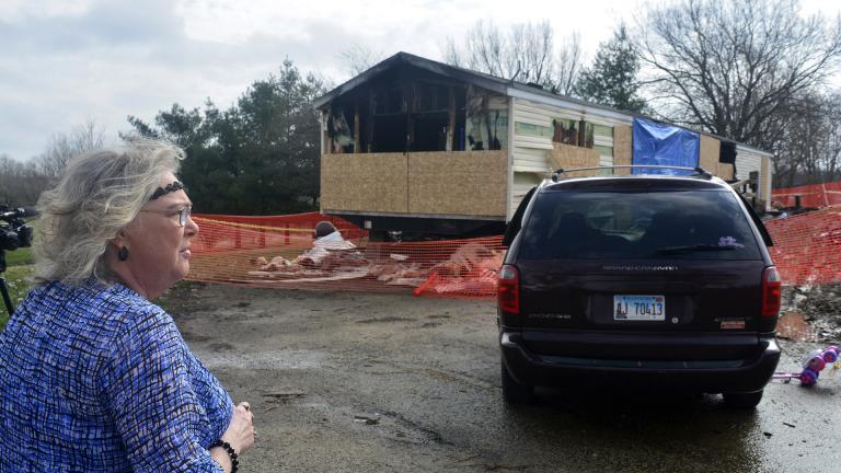 In this Sunday, April 7, 2019, file photo, Marie Chockley, a resident of the Timberline Trailer Court, north of Goodfield, Illinois, surveys the damage that was caused by a Saturday night fire that killed five residents in a mobile home. (Kevin Barlow / The Pantagraph via AP, File)