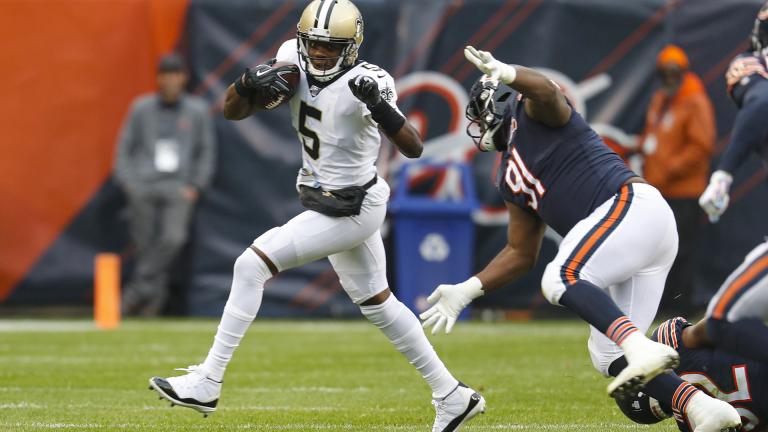 New Orleans Saints quarterback Teddy Bridgewater (5) is chased by Chicago Bears nose tackle Eddie Goldman (91) during the first half of an NFL football game in Chicago, Sunday, Oct. 20, 2019. (AP Photo / Charles Rex Arbogast)