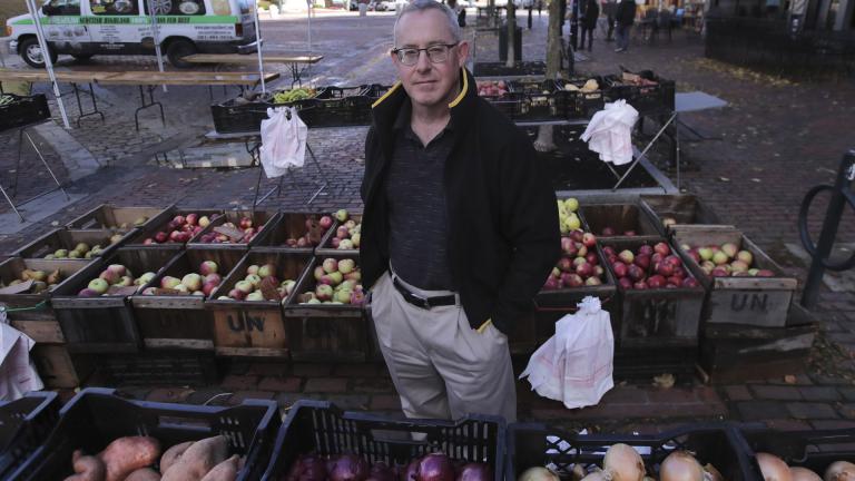 John Gold, self-employed graphics designer, poses at a farmer's market outside his office in Portland, Maine, Wednesday, Oct. 23, 2019. (AP Photo / Charles Krupa)