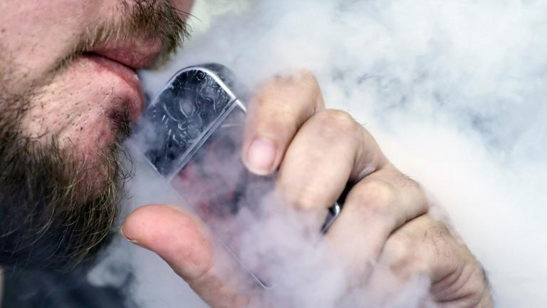 In this Friday, Oct. 4, 2019, file photo, a man using an electronic cigarette exhales in Mayfield Heights, Ohio. (AP Photo / Tony Dejak, File)