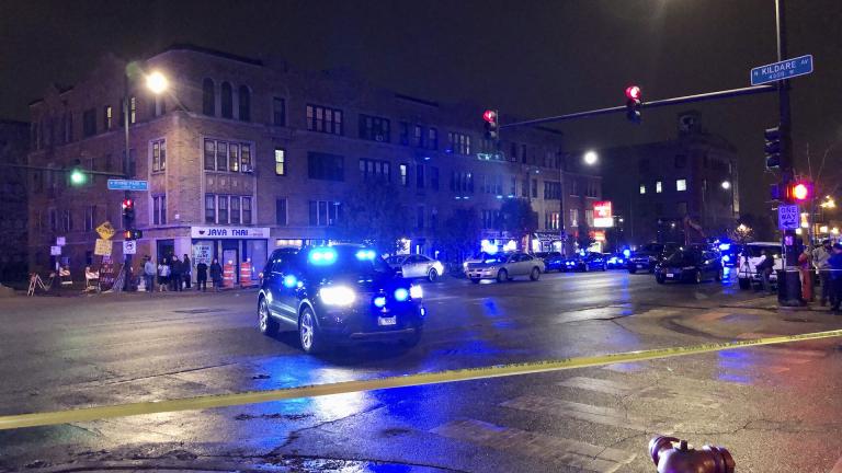 Chicago Police investigate the scene where an officer was shot by a suspected bank robber in Chicago, Tuesday night, Nov. 19, 2019. A 15-year-old boy was also wounded in the shooting, while the suspect was shot and killed. (Sam Charles / Chicago Sun-Times via AP) Chicago Police investigate the scene where an officer was shot by a suspected bank robber in Chicago, Tuesday night, Nov. 19, 2019. A 15-year-old boy was also wounded in the shooting, while the suspect was shot and killed. (Sam Charles / Chicago Sun-Times via AP)