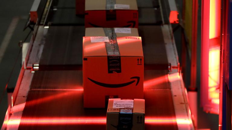 In this Aug. 1, 2017, file photo, packages riding on a belt are scanned to be loaded onto delivery trucks at the Amazon Fulfillment center in Robbinsville Township, New Jersey. (AP Photo / Julio Cortez, File)