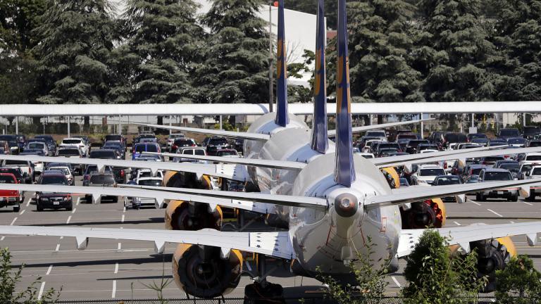 In this Thursday, Aug. 15, 2019, file photo, three grounded Boeing 737 Max airplanes, built for Icelandair, sit parked in a lot normally used for cars in an area adjacent to Boeing Field, in Seattle. (AP Photo / Elaine Thompson, File)