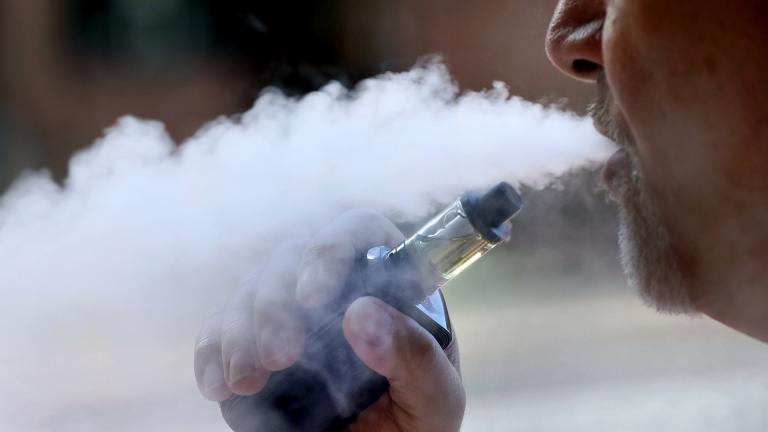 In this Aug. 28, 2019, file photo, a man exhales while smoking an e-cigarette in Portland, Maine. (AP Photo / Robert F. Bukaty, File)