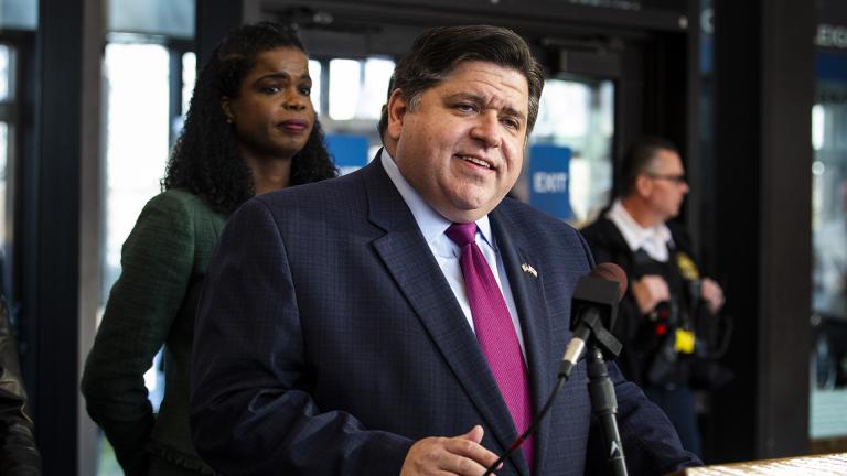 Cook County State’s Attorney Kim Foxx looks on as Illinois Gov. J.B. Pritzker speaks during a press conference in Chicago after Foxx filed motions to vacate more than 1,000 low-level cannabis convictions, Wednesday, Dec. 11, 2019. (Ashlee Rezin Garcia / Chicago Sun-Times via AP)