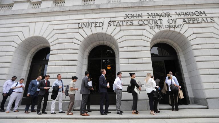 In this Tuesday, July 9, 2019 file photo, people wait in line to enter the 5th Circuit Court of Appeals to sit in overflow rooms to hear arguments in New Orleans. (AP Photo / Gerald Herbert, File)