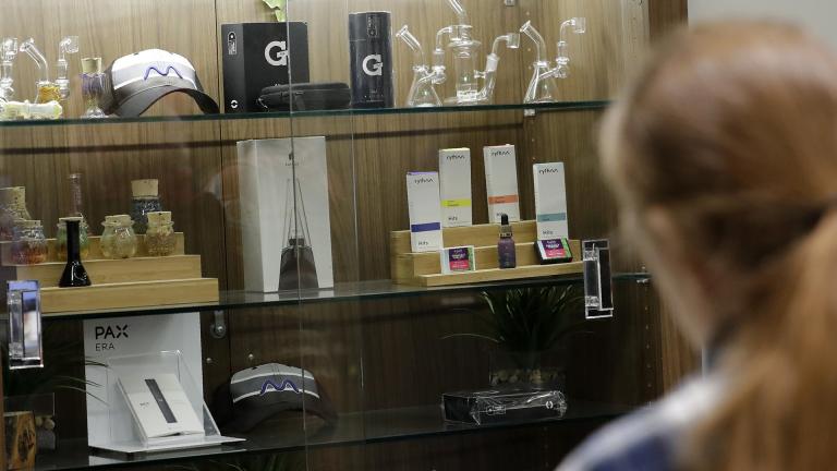 In this Thursday, Dec. 26, 2019 photo, a registered medical marijuana patient looks at products at the Rise cannabis store in Mundelein, Illinois. Starting Jan. 1, 2020, Illinois will join Michigan as the only Midwestern states broadly allowing the sale and use of marijuana. (AP Photo / Nam Y. Huh)