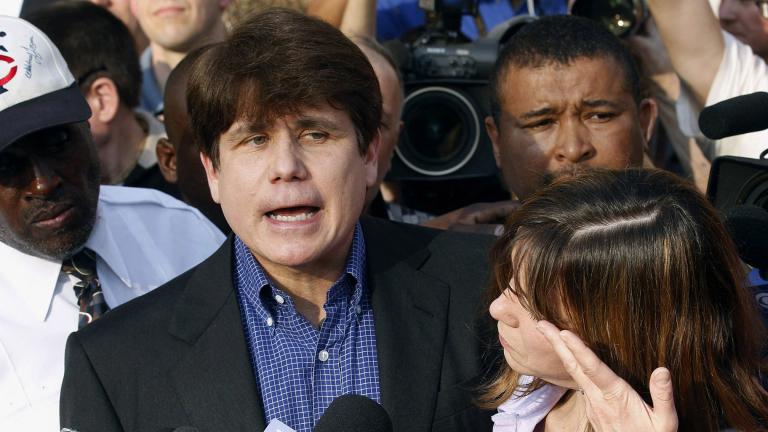 In this March 14, 2012, file photo, former Illinois Gov. Rod Blagojevich speaks to the media outside his home in Chicago as his wife, Patti, wipes away tears a day before reporting to prison after his conviction on corruption charges. (AP Photo / M. Spencer Green, File)