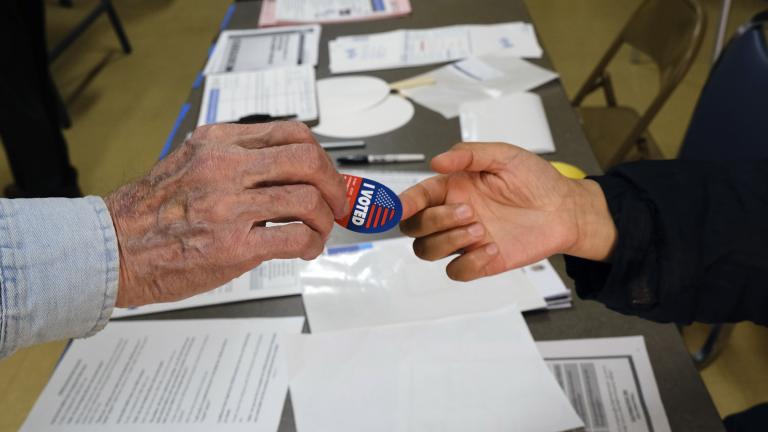 Early voter receives his I-Voted sticker, at an early voting polling station at the Ranchito Avenue Elementary School in the Panorama City section of Los Angeles on Monday, March 2, 2020. (AP Photo / Richard Vogel)