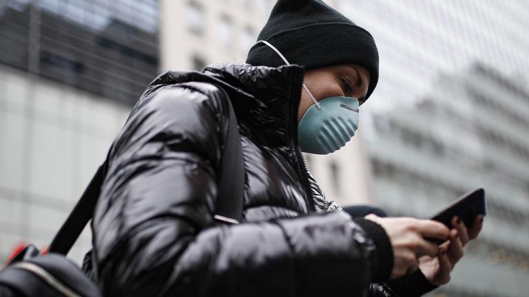 Pedestrian uses her phone while wearing a face mask in Herald Square, Thursday, March 12, 2020, in New York. (AP Photo / John Minchillo) Pedestrian uses her phone while wearing a face mask in Herald Square, Thursday, March 12, 2020, in New York. (AP Photo / John Minchillo)