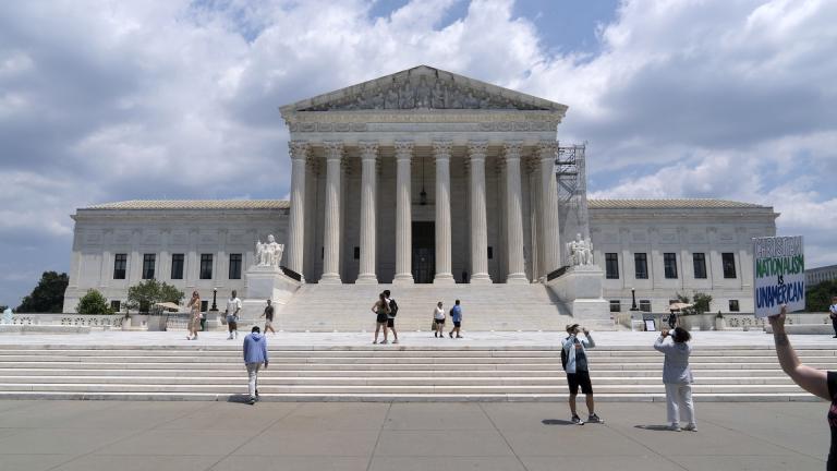 Visitors pose for photographs outside the U.S. Supreme Court Tuesday, June 18, 2024, in Washington. ( AP Photo/Jose Luis Magana)
