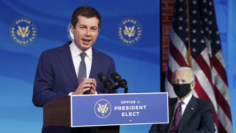 Former South Bend, Ind. Mayor Pete Buttigieg, President-elect Joe Biden's nominee to be transportation secretary reacts to his nomination as Biden looks on during a news conference at The Queen theater in Wilmington, Del., Wednesday, Dec. 16, 2020. (Kevin Lamarque / Pool via AP)