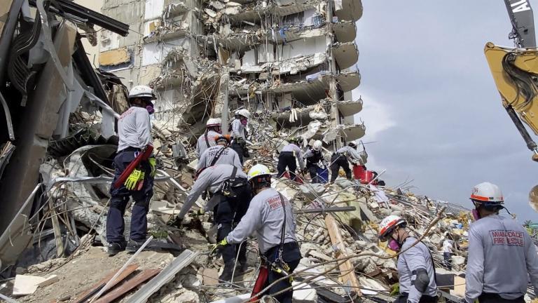 This photo provided by Miami-Dade Fire Rescue, search and rescue personnel search for survivors through the rubble at the Champlain Towers South Condo in Surfside, Fla., section of Miami, Friday, June 25, 2021. The apartment building partially collapsed on Thursday. (Miami-Dade Fire Rescue via AP)