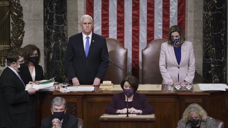 Vice President Mike Pence and Speaker of the House Nancy Pelosi, D-Calif., read the final certification of Electoral College votes cast in November's presidential election during a joint session of Congress after working through the night, at the Capitol in Washington, Thursday, Jan. 7, 2021. (AP Photo/J. Scott Applewhite, Pool)