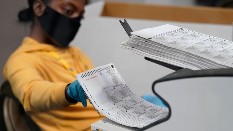 A county election worker scans mail-in ballots at a tabulating area at the Clark County Election Department, Thursday, Nov. 5, 2020, in Las Vegas. (AP Photo / John Locher)