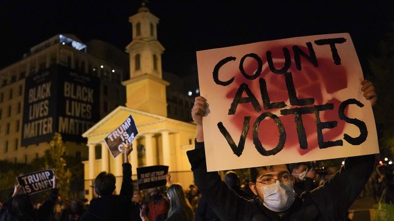 A demonstrator holds up a sign while waiting for election results at Black Lives Matter Plaza, Tuesday, Nov. 3, 2020, in Washington. (AP Photo / John Minchillo)