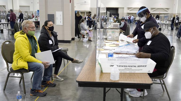 Election workers, right, verify ballots as recount observers, left, watch during a Milwaukee hand recount of presidential votes at the Wisconsin Center, Friday, Nov. 20, 2020, in Milwaukee. (AP Photo / Nam Y. Huh)