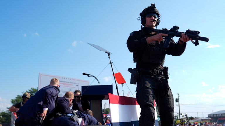 Republican presidential candidate former President Donald Trump is covered by U.S. Secret Service agents at a campaign rally, Saturday, July 13, 2024, in Butler, Pa. (AP Photo / Evan Vucci)