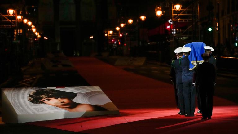 Pictures of Josephine Baker adorn the red carpet as the coffin with soils from the U.S., France and Monaco is carried towards the Pantheon monument in Paris, France, Tuesday, Nov. 30, 2021, where Baker is to symbolically be inducted, becoming the first Black woman to receive France's highest honor. Her body will stay in Monaco at the request of her family. (AP Photo / Christophe Ena)