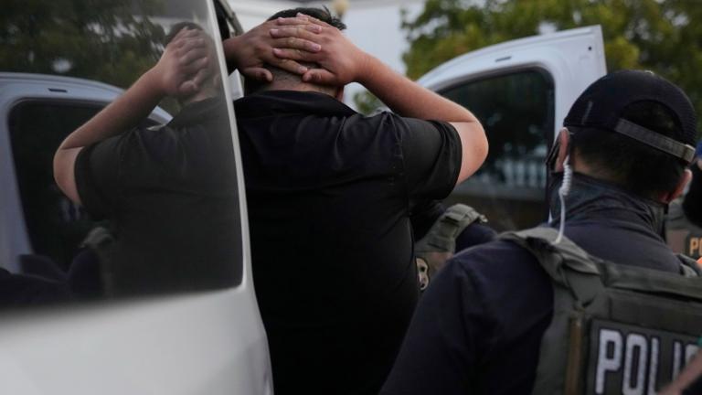 U.S. Immigration and Customs Enforcement agents make an arrest during an early morning operation in Park Ridge, Ill., Friday, Sept. 19, 2025. (AP Photo / Erin Hooley)