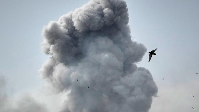 A bird flies by a plume of smoke rising after a strike in Tehran, Iran, Monday, March 2, 2026. (AP Photo/Vahid Salemi)