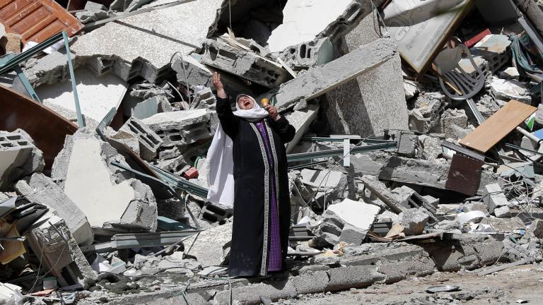 A woman reacts while standing near the rubble of a building that was destroyed by an Israeli airstrike on Saturday that housed The Associated Press, broadcaster Al-Jazeera and other media outlets, in Gaza City, Sunday, May 16, 2021. (AP Photo / Adel Hana)